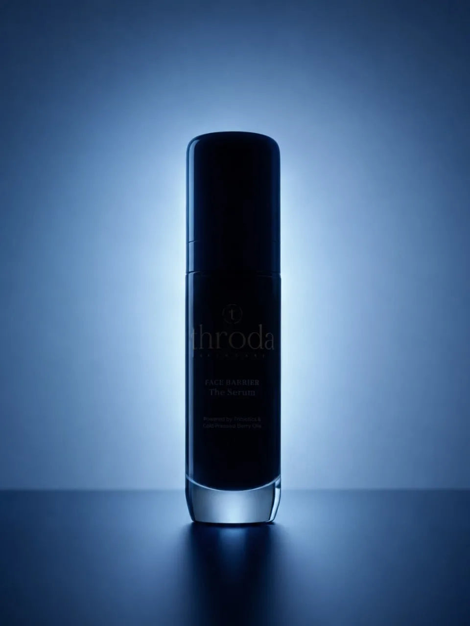 The Face Barrier Serum illuminated against blue light